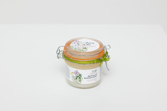 Apricot scrub with lemon balm essential oil in a 250g glass jar with wire closure. Natural exfoliant featuring apricot kernel oil and lemon balm for gentle exfoliation and skin toning. Ideal for normal and problem skin types.